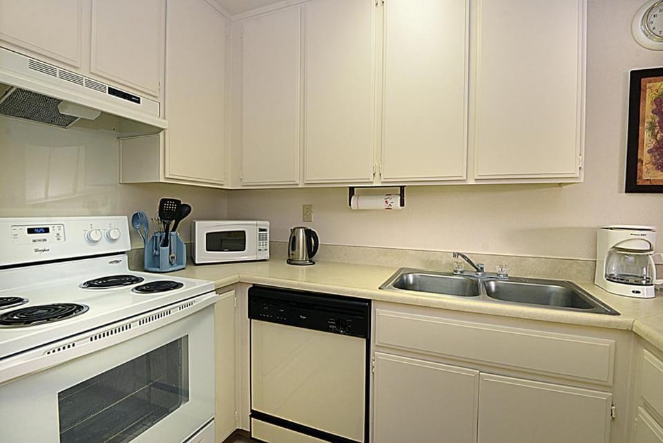 Kitchen or kitchenette, dishwasher, oven, stove