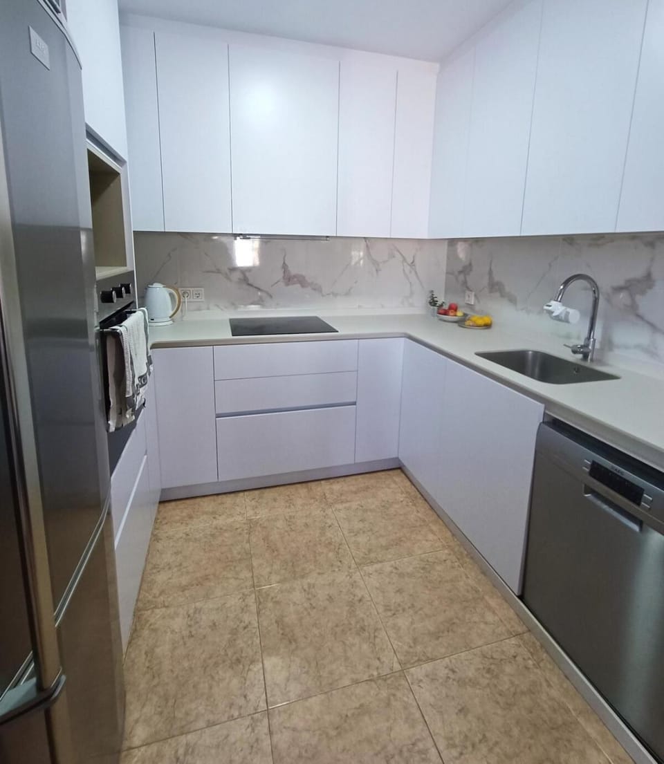 Kitchen or kitchenette, dishwasher, oven, stove