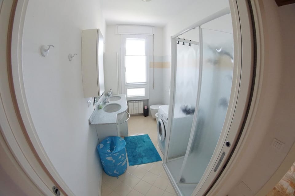 Shower, Toilet, Bathroom, bidet, hair dryier, towels, washing machine