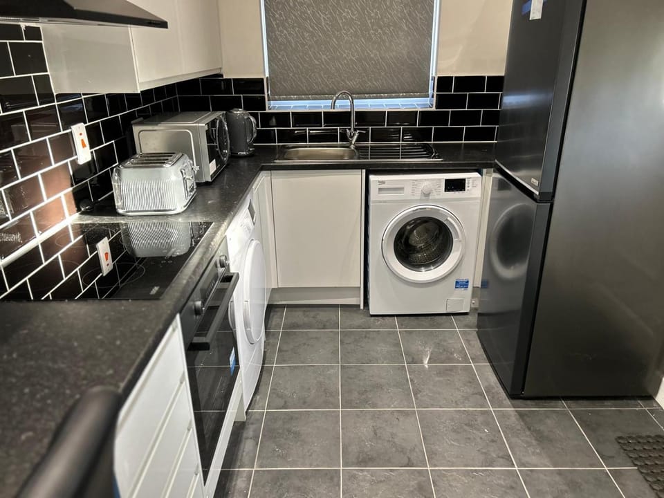 Kitchen or kitchenette, oven, stove, toaster, washing machine, dryer
