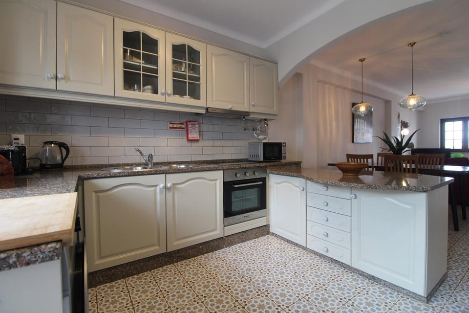 Kitchen or kitchenette, dishwasher, oven, stove