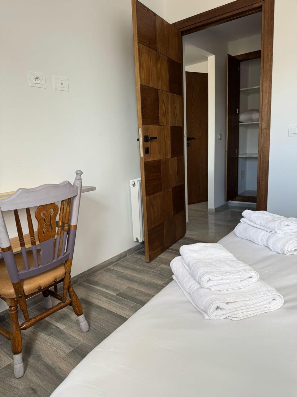 Bed, towels, wardrobe