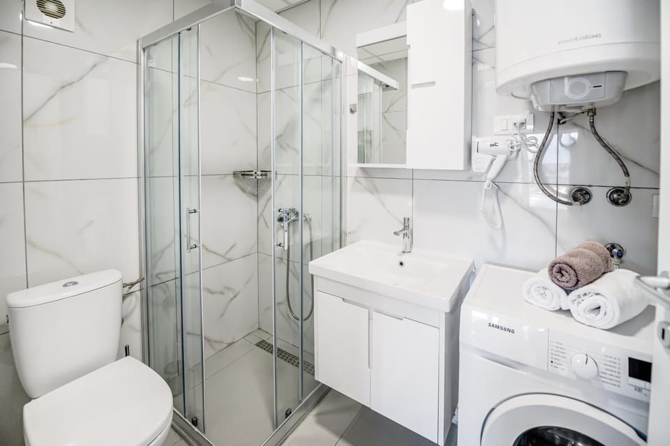 Shower, Toilet, Bathroom, towels, washing machine, dryer