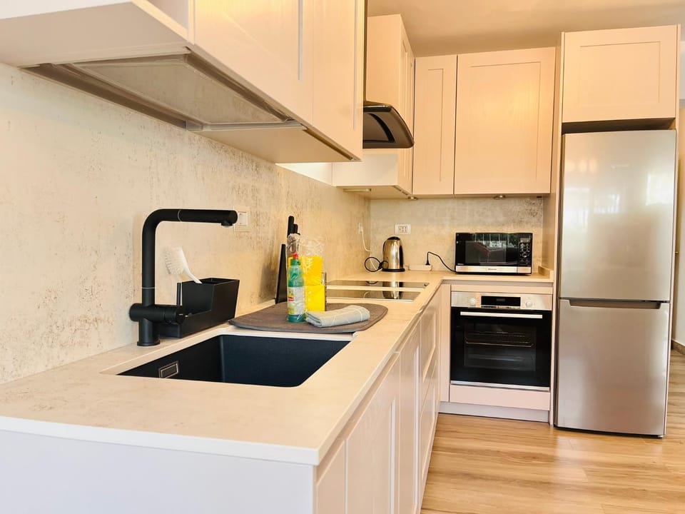 Kitchen or kitchenette, dishwasher, oven, stove