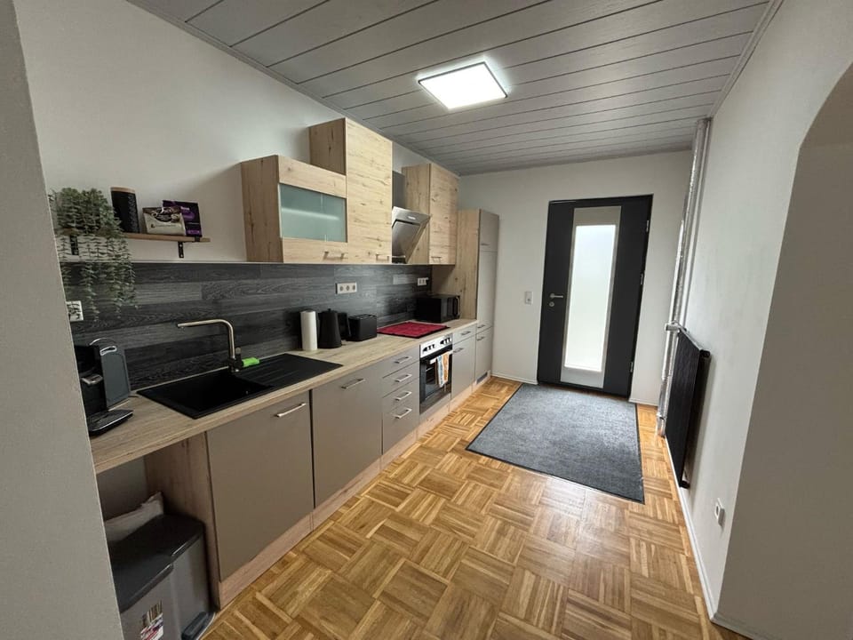 Kitchen or kitchenette, dishwasher, oven, stove