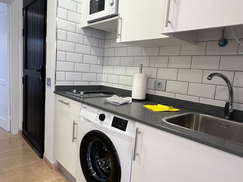 Kitchen or kitchenette, stove, washing machine