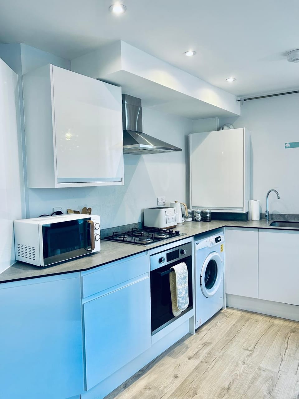 Kitchen or kitchenette, oven, stove, toaster, washing machine
