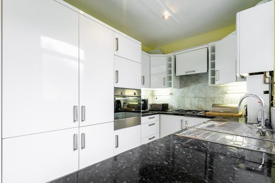 Kitchen or kitchenette, dishwasher, oven, stove, toaster, washing machine