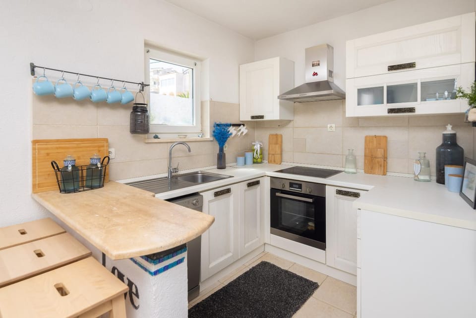 Kitchen or kitchenette, dishwasher, oven, stove