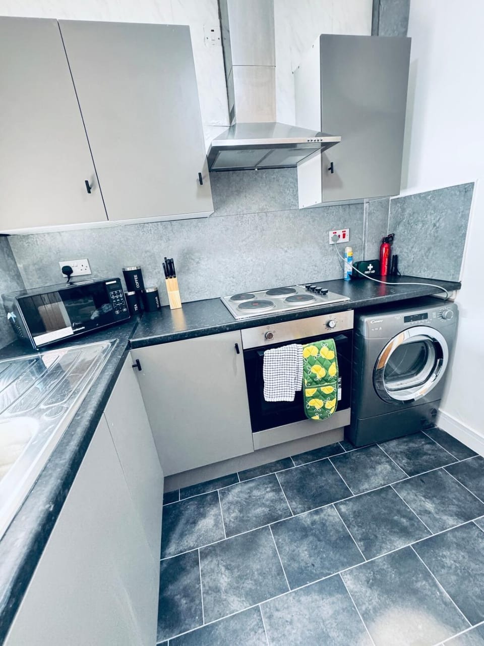 Kitchen or kitchenette, oven, stove, toaster, washing machine, dryer