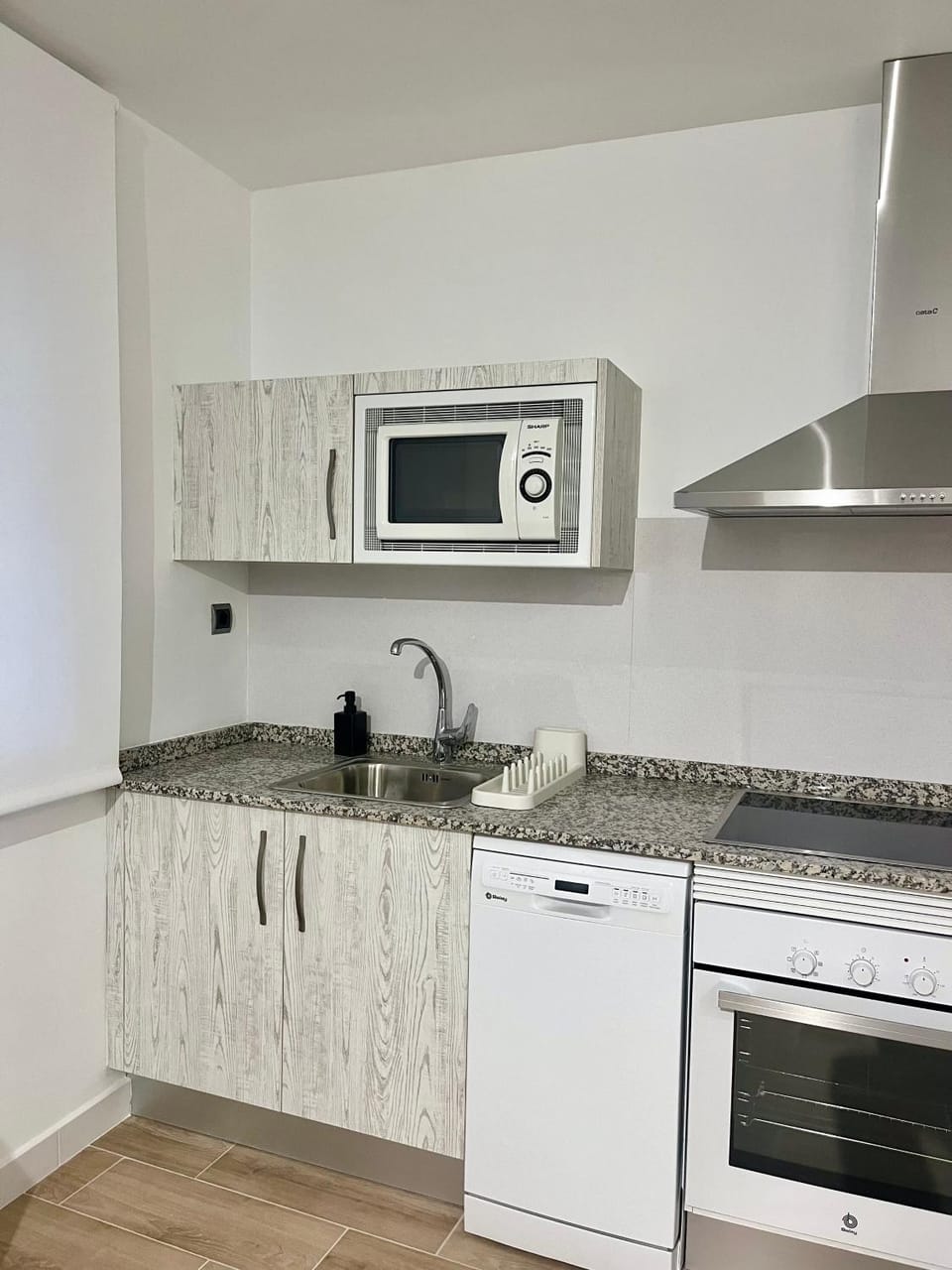 Kitchen or kitchenette, dishwasher, microwave, oven, stove, toaster