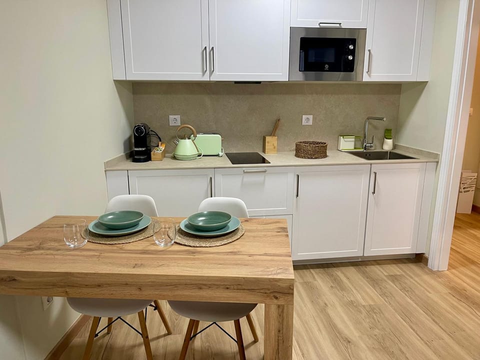 Kitchen or kitchenette, microwave, stove, washing machine, dryer