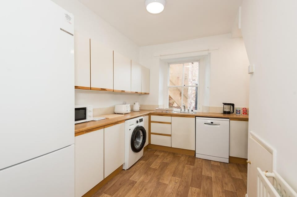 Kitchen or kitchenette, dishwasher, stove, toaster, washing machine