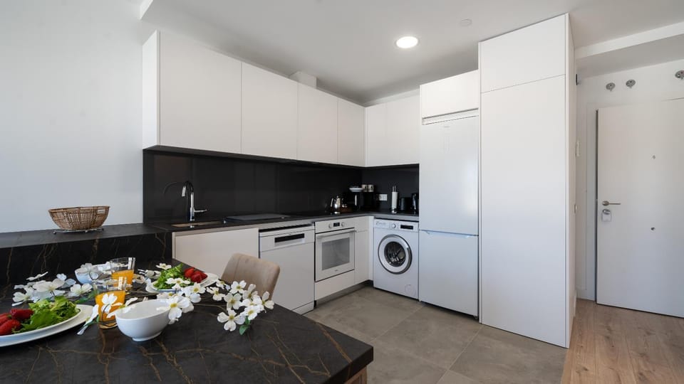 Kitchen or kitchenette, dishwasher, oven, stove, washing machine