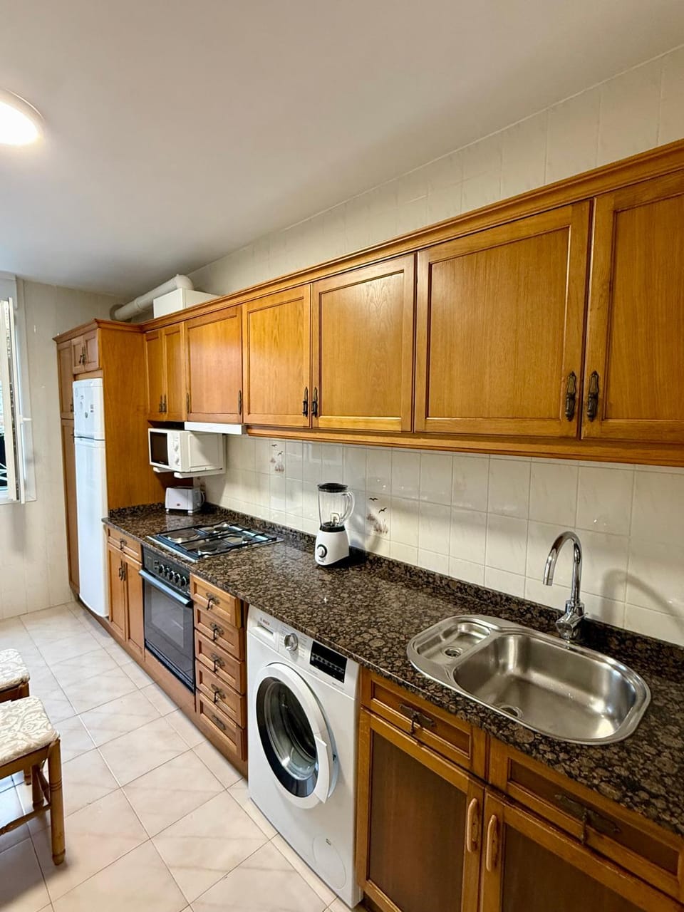 Kitchen or kitchenette, oven, stove, washing machine