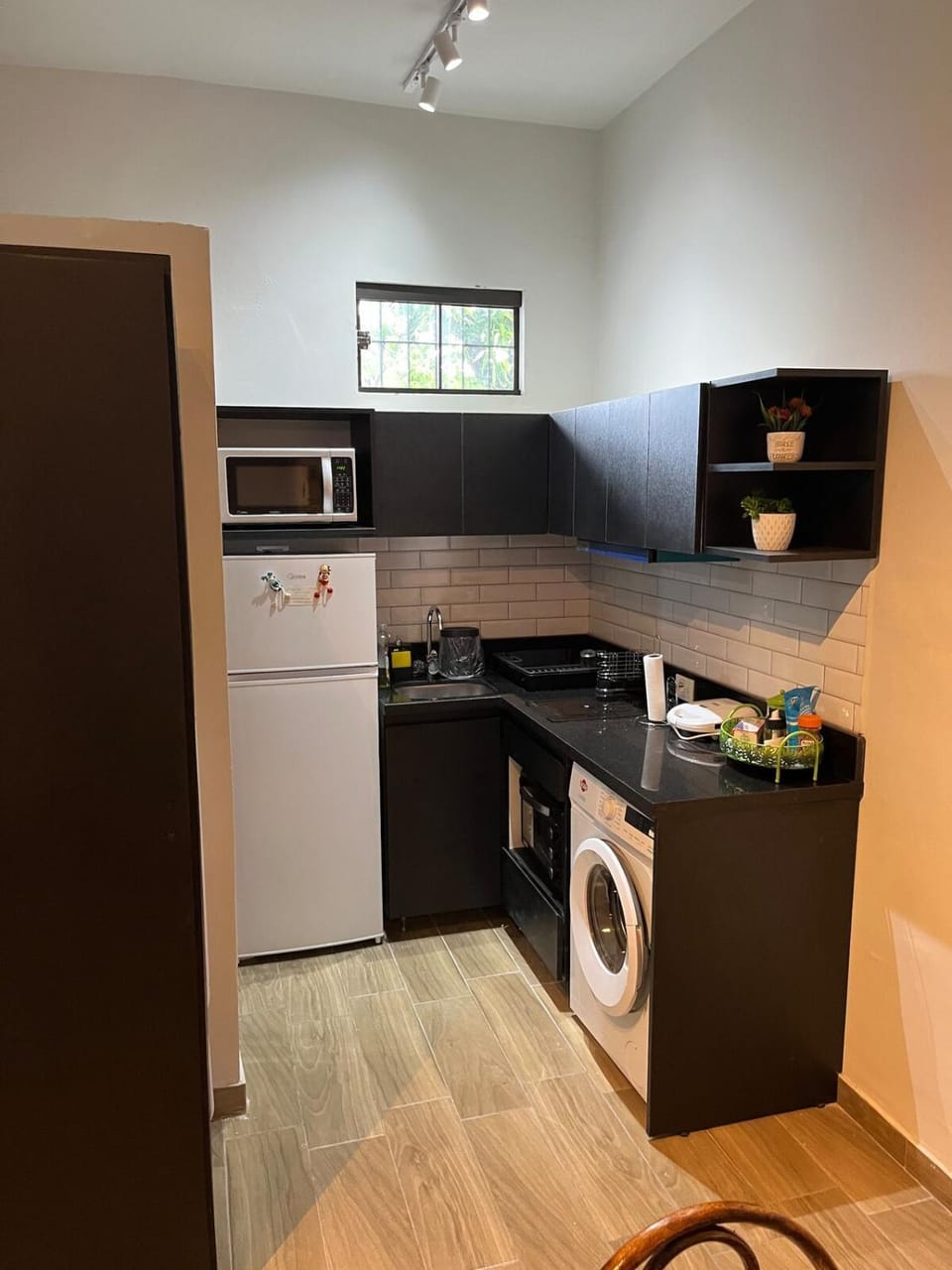 Kitchen or kitchenette, dishwasher, oven, stove, toaster, laundry, washing machine
