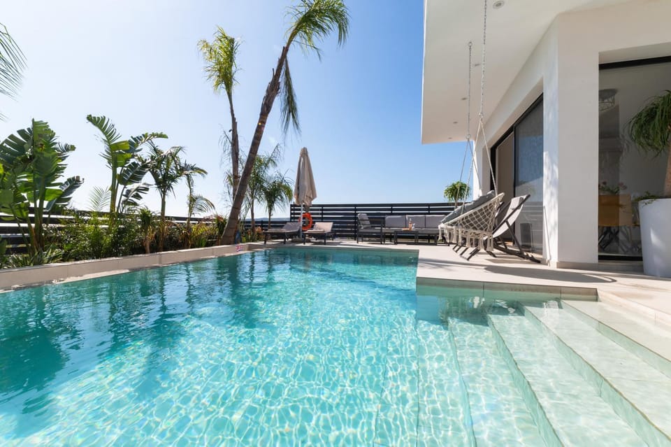 Property building, Patio, Pool view, Swimming pool, sunbed