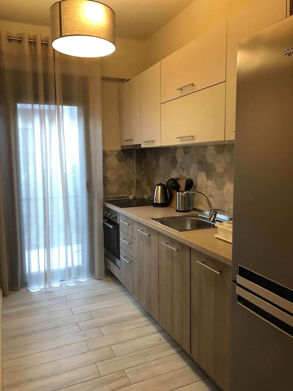 Kitchen or kitchenette, dishwasher, oven, stove