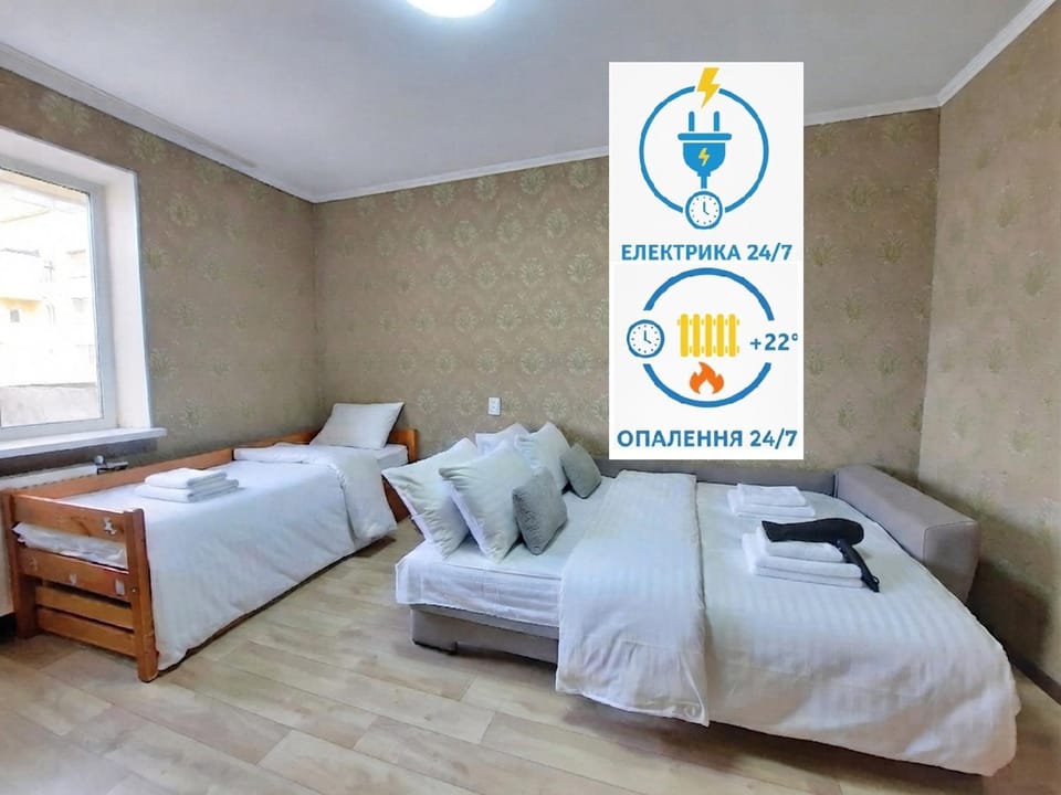 Bed, Property logo or sign, Photo of the whole room, Logo/Certificate/Sign, Bedroom, Text overlay, Certificate/Award, towels