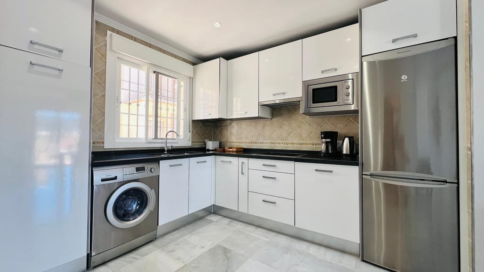 Kitchen or kitchenette, stove, toaster, washing machine