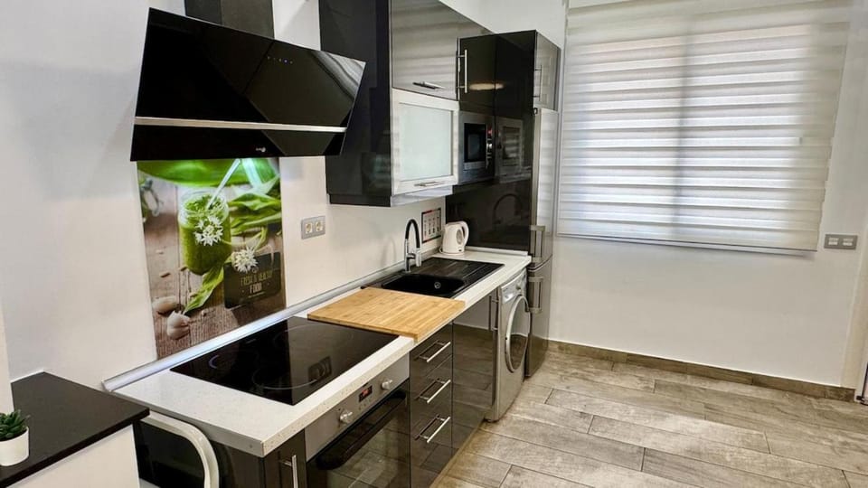 Kitchen or kitchenette, microwave, oven, stove, washing machine
