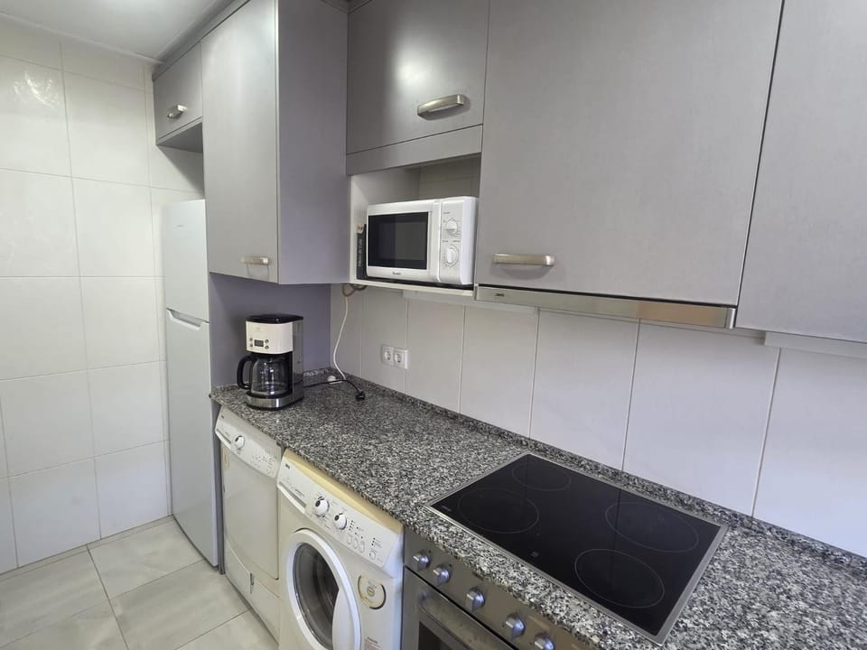 Kitchen or kitchenette, dishwasher, oven, stove, toaster, washing machine, dryer