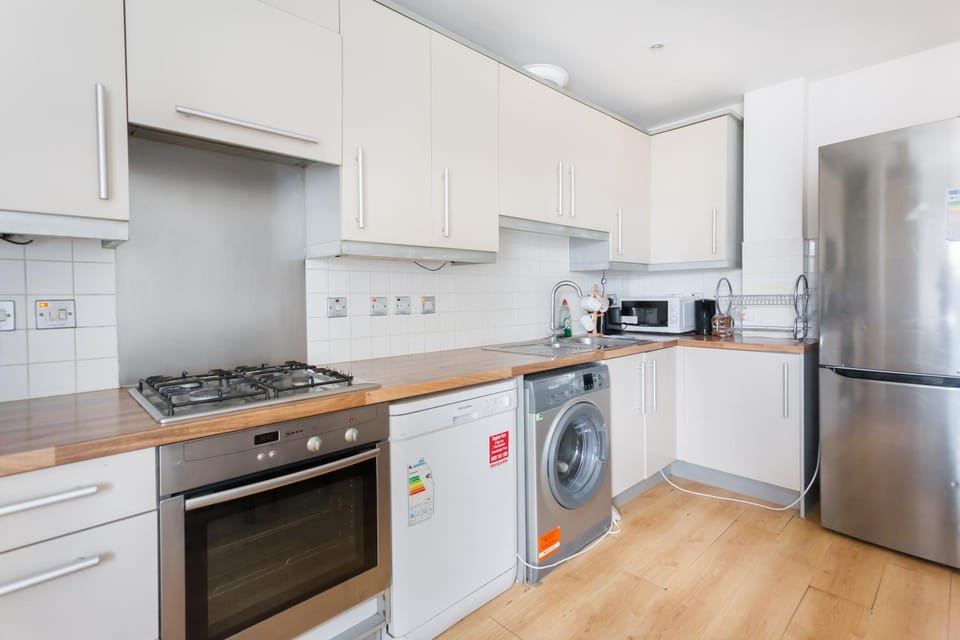 Kitchen or kitchenette, dishwasher, oven, stove, toaster, washing machine, dryer