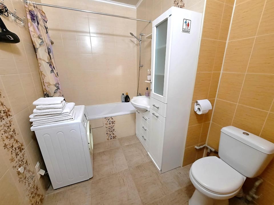 Shower, Toilet, Bathroom, hair dryier, towels, washing machine, dryer