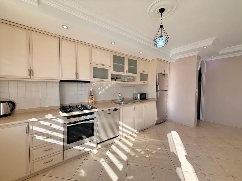 Kitchen or kitchenette, dishwasher, oven, stove
