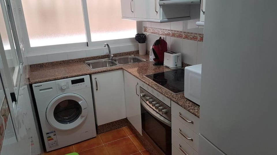 Kitchen or kitchenette, stove, washing machine