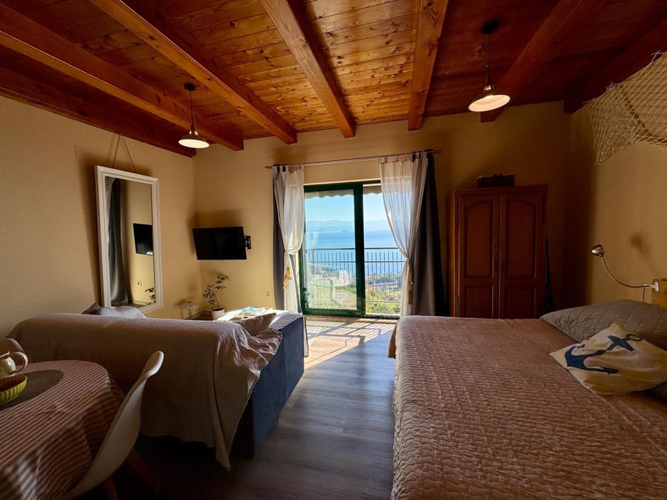 Bed, Natural landscape, TV and multimedia, Living room, Photo of the whole room, Seating area, Bedroom, Sea view