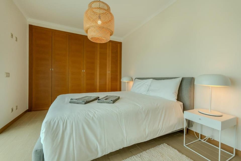 Bed, towels, wardrobe