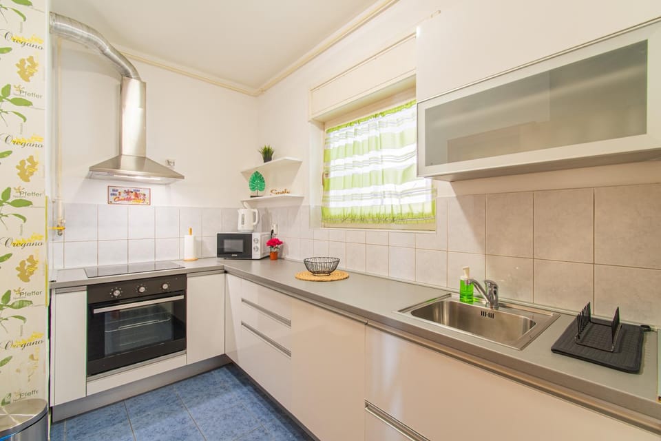Kitchen or kitchenette, dishwasher, microwave, oven, stove