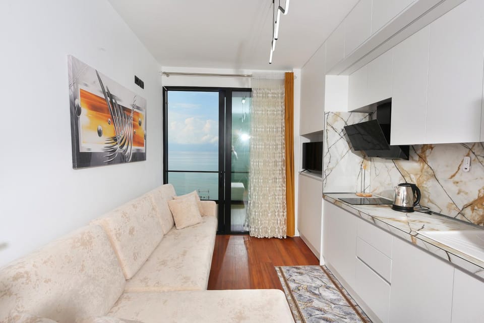 People, TV and multimedia, Kitchen or kitchenette, Living room, Seating area, Sea view, Sea view, furniture, furniture, minibar, oven