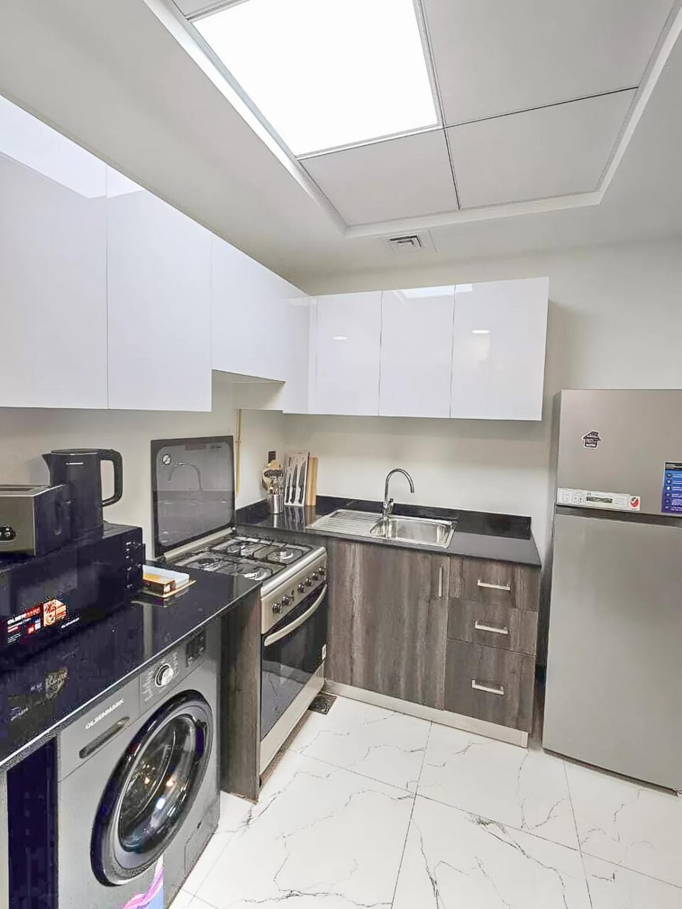 Kitchen or kitchenette, dishwasher, oven, stove, toaster, washing machine