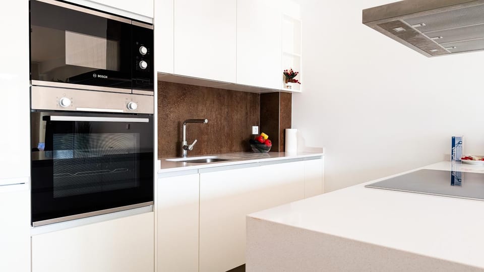 Kitchen or kitchenette, dishwasher, oven, stove