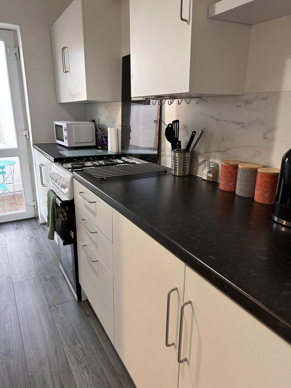 Kitchen or kitchenette, microwave, oven, stove