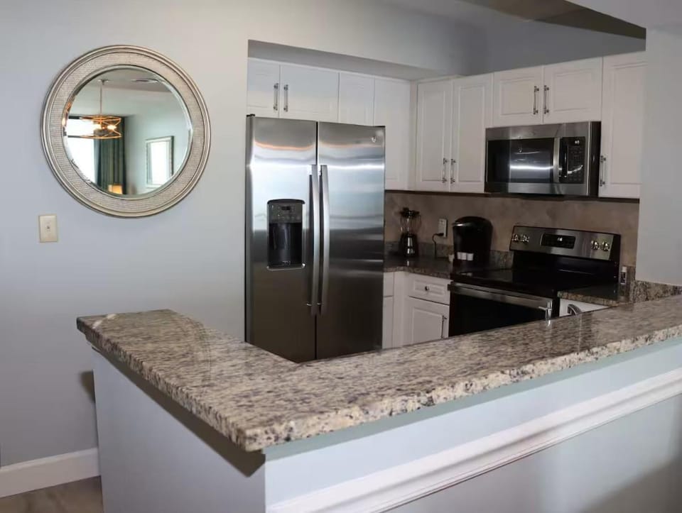 Kitchen or kitchenette, dishwasher, oven, stove