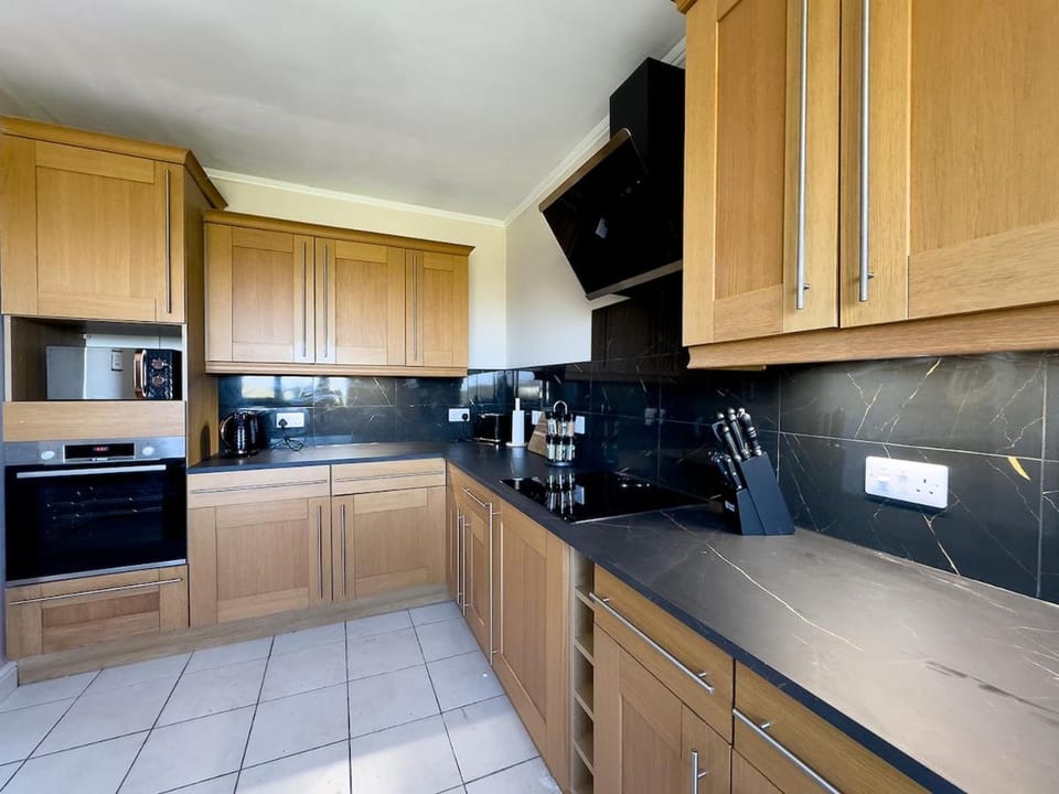 Kitchen or kitchenette, dishwasher, oven, stove, toaster