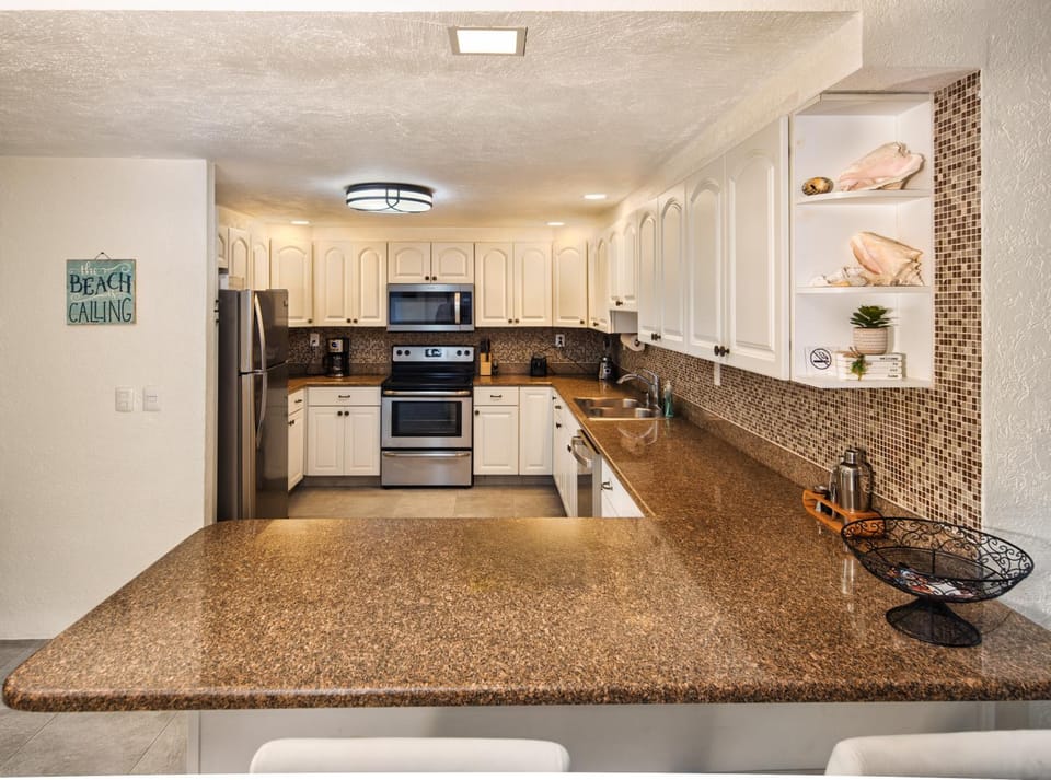 Kitchen or kitchenette, dishwasher, oven, stove, toaster