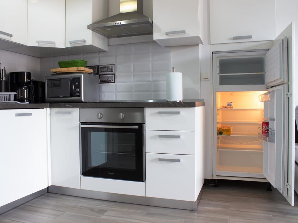 Kitchen or kitchenette, dishwasher, oven, stove