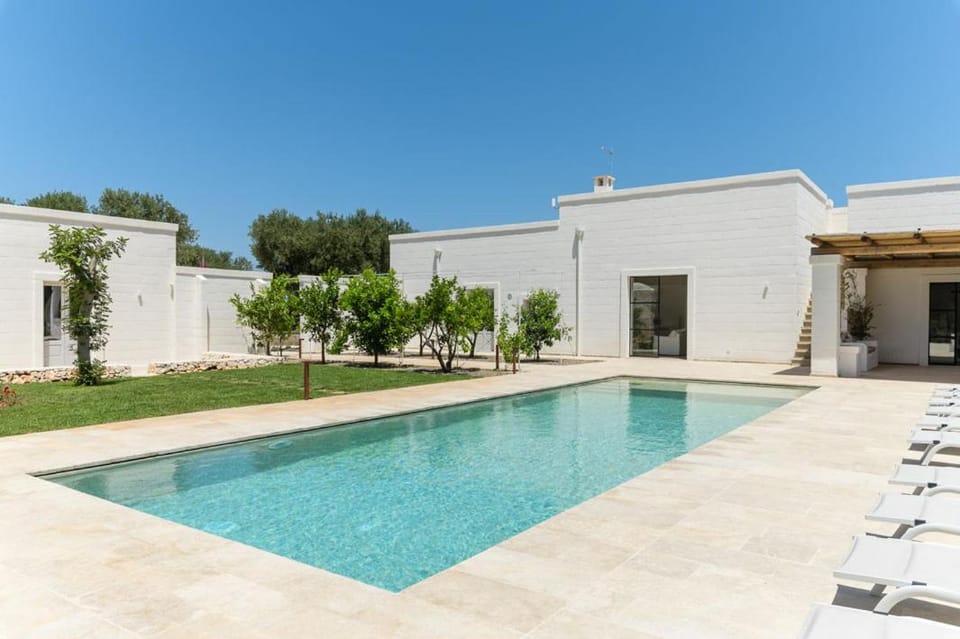 Property building, Patio, Pool view, Swimming pool, sunbed