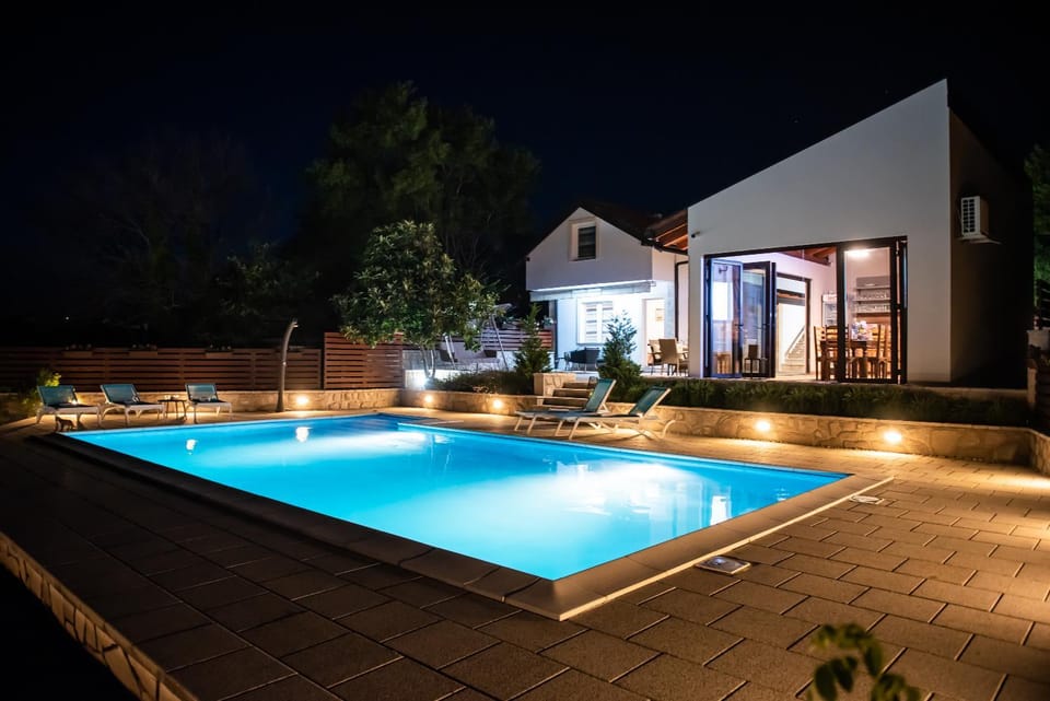 Property building, Patio, Night, Pool view, Swimming pool, sunbed