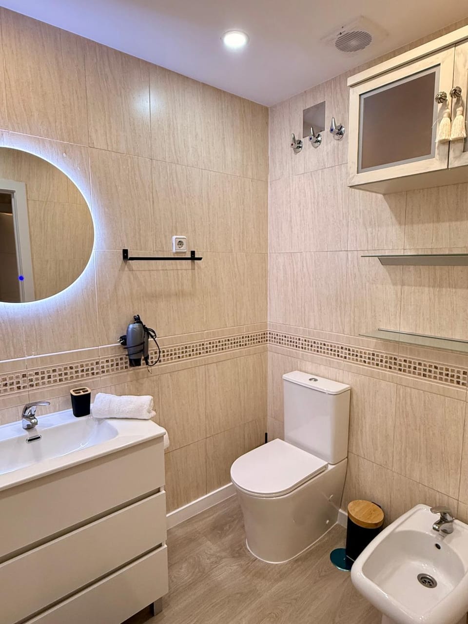 Toilet, Bathroom, bidet, hair dryier, storage, towels