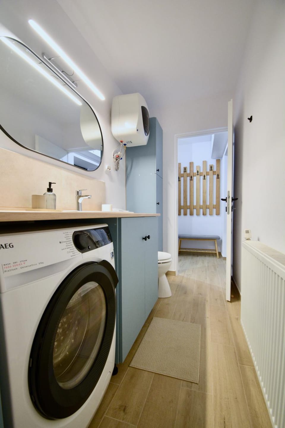Toilet, Bathroom, hair dryier, towels, washing machine, dryer