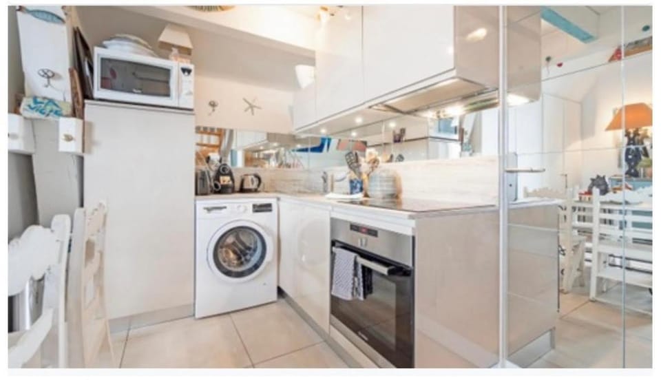 Kitchen or kitchenette, dishwasher, oven, stove, washing machine