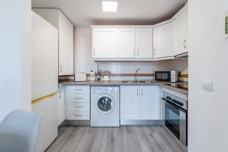 Kitchen or kitchenette, oven, stove, toaster, washing machine