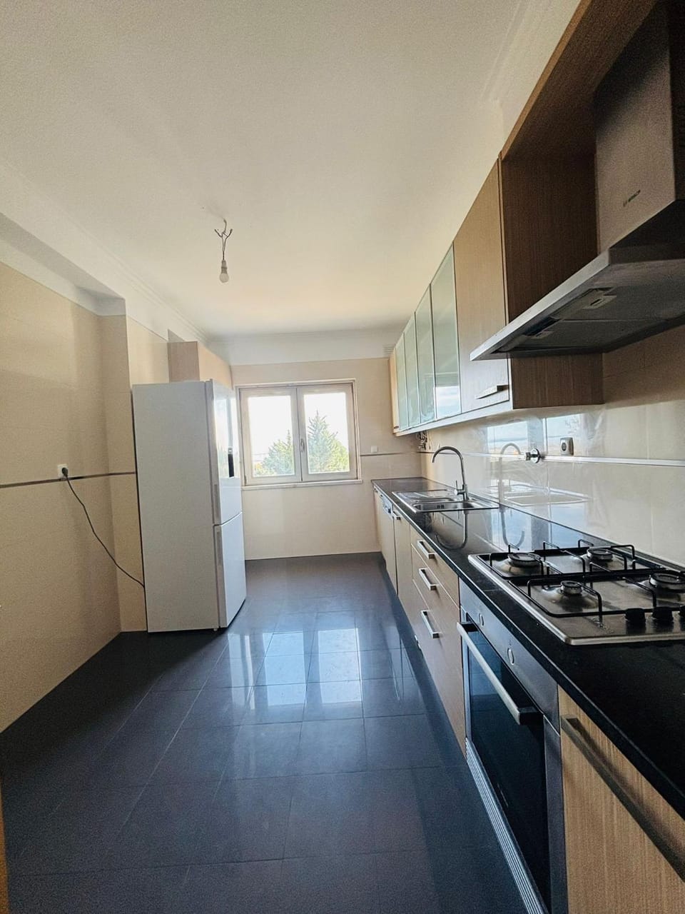 Kitchen or kitchenette, dishwasher, oven, stove