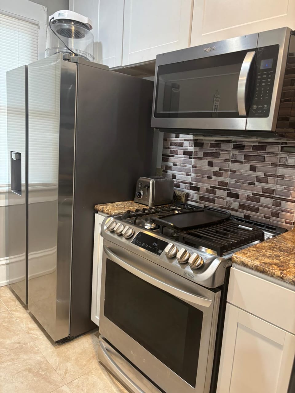 Kitchen or kitchenette, dishwasher, microwave, oven, stove