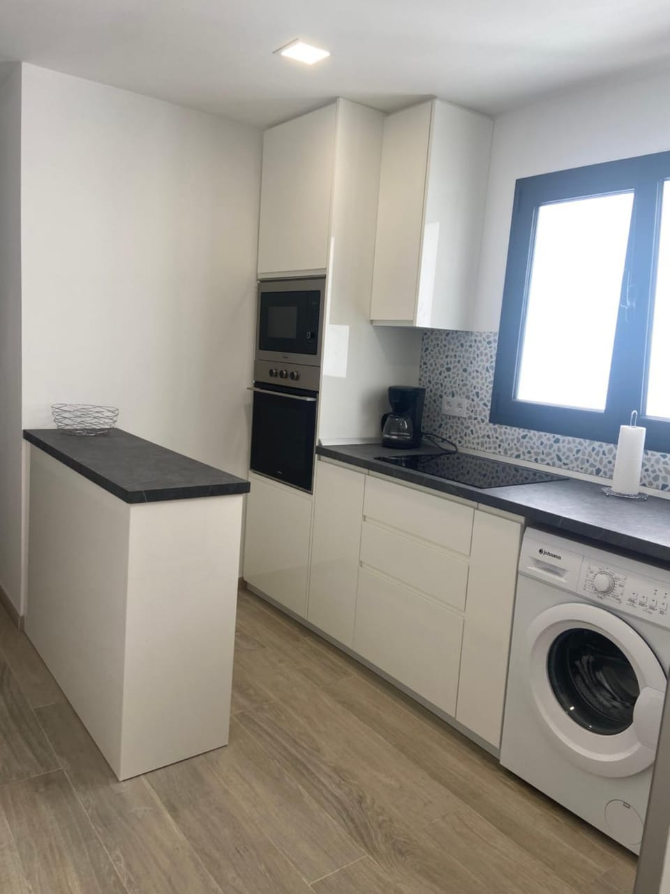 Kitchen or kitchenette, dishwasher, microwave, oven, stove, washing machine